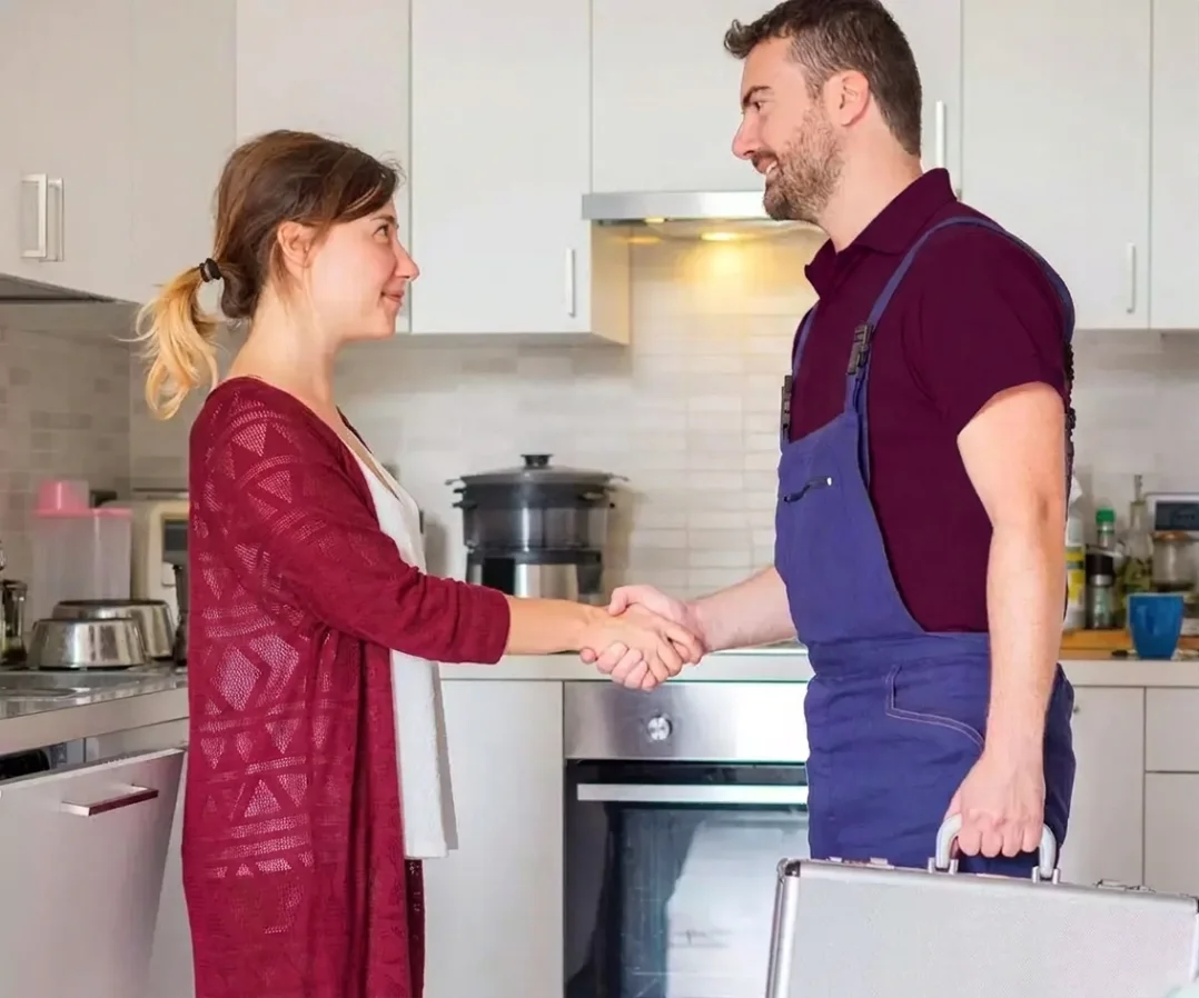 Vendor and customer shaking hands in a kitchen